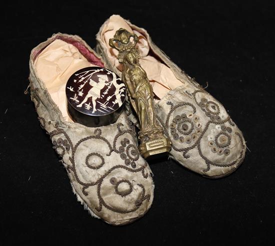 A pair of silkwork childs shoes, a French bronze desk seal and a small pot